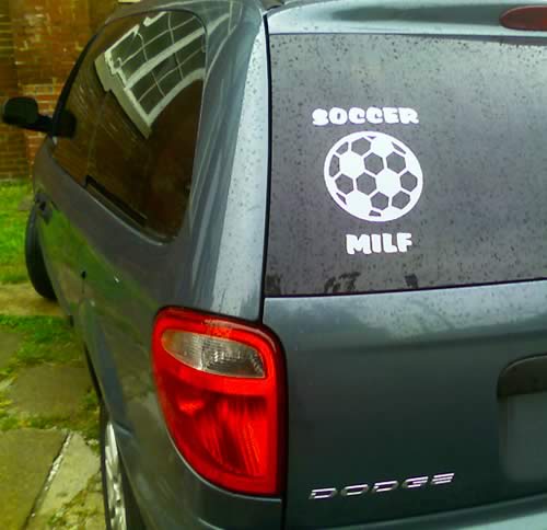 Dodge Van with a'Soccer MILF' sticker in the rear window