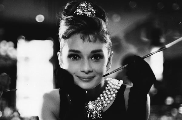 Audrey Hepburn with a cigerette holder in \"Breakfast at Tiffany\'s\"