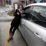 Julie Tyios leans up against one of the Ford C-MAXes.