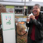 Joey deVilla licking the electric car charger