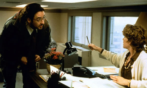 John Cusack and Caroline Keener in a "tiny office" scene from "Being John Malovich"