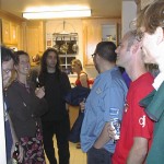 People gathered in a kitchen at a party.