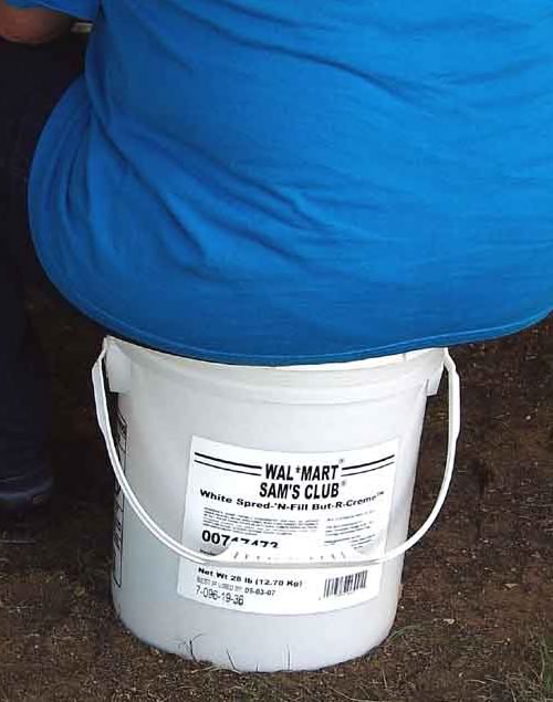 A fat butt on a tub of Wal-Mart But-R-Creme