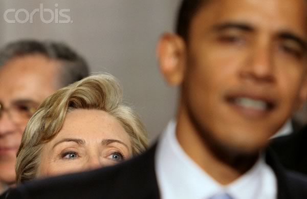 Photo: Blurry Obama in the foreground with an in-focus Hillary Clinton peeking over his shoulder.