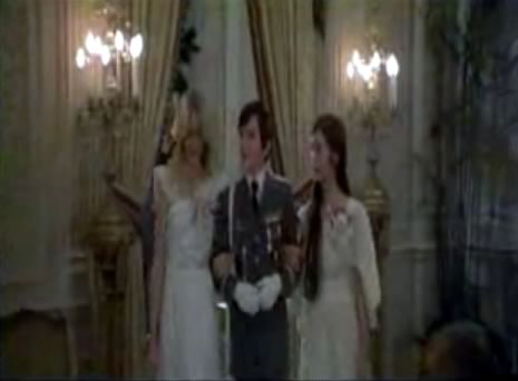 Still from “Omen II”: Damien in uniform, with a comely lass on each arm.