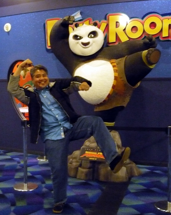 Joey deVilla posing in front of the “Kung Fu Panda” display