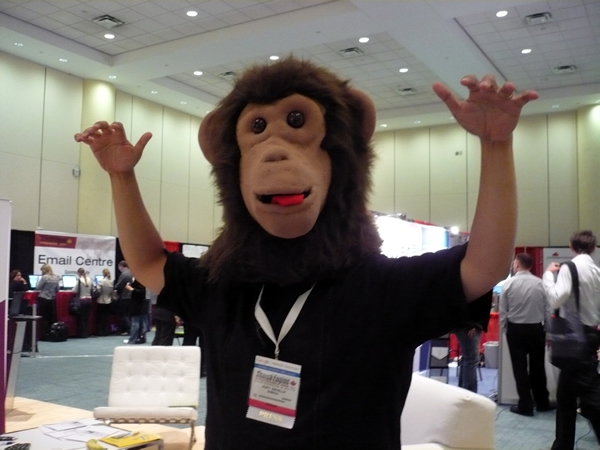 Joey deVilla wearing the head from a monkey costume on the trade show floor at Search Engine Strategies Toronto 2008