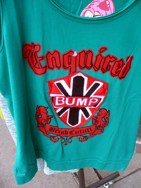 Engrish t-shirt that reads \"Enquired bump brsuh culuff\"