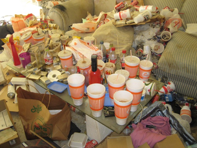 Living room of trash-strewn house