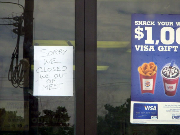 Handwritten sign on Burger King door: "SORRY WE CLOSED WE OUT OF MEET"