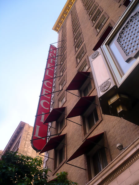 1. Exterior of the Hotel Cecil during the day, showing its vertical sign