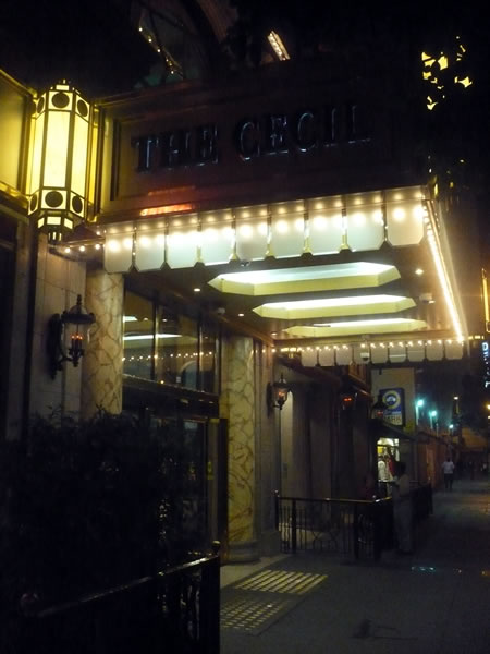 5. Exterior of Hotel Cecil at night, showing the marquee