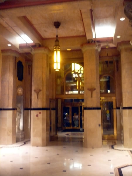 7. Hotel Cecil's marble lobby, looking out