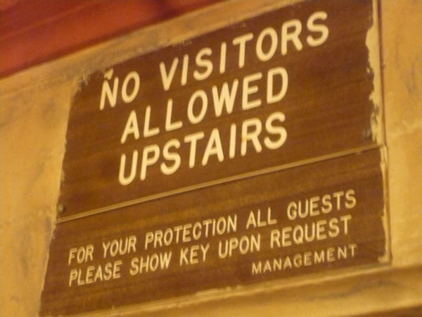 10. "No visitors allowed upstairs" sign