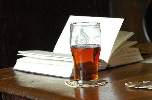 A glass of beer and a book
