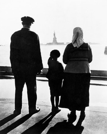 Immigrant family on Ellis Island looking at the Statue of Liberty in the distance