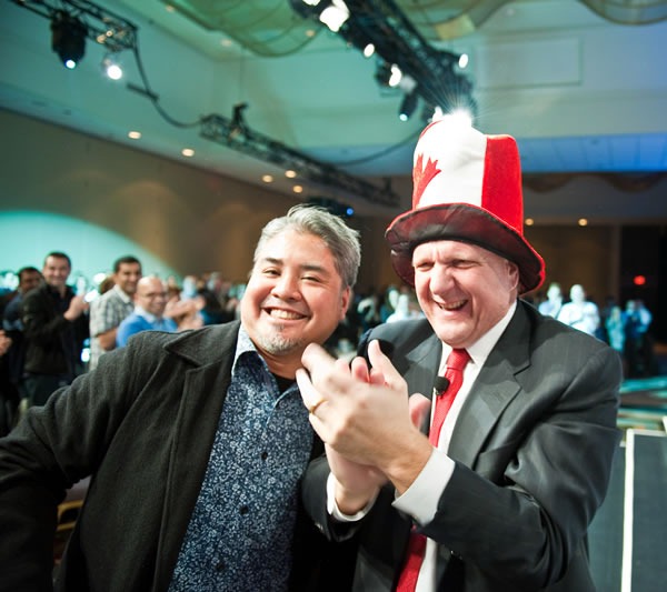 Joey deVilla and Steve Ballmer, wearing Joey's Canadian flag raver hat