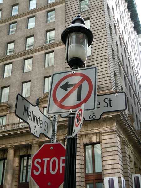 Street signs at the corner of Yonge and Melinda Streets, with a "No Left Turn" sign blocking the Yonge Street sign