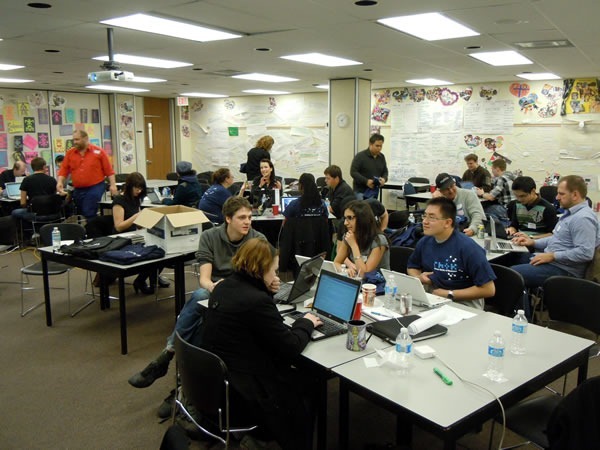 The main RHoK room as seen from the front, packed with developers working at various tables