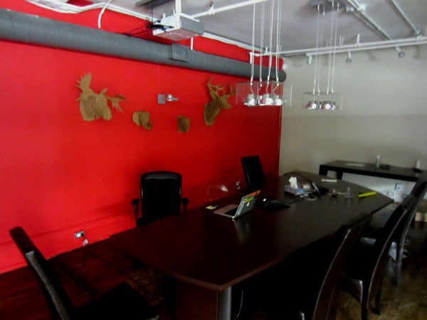 Shopify's boardroom, with cardboard animal "trophies" hanging on the far wall