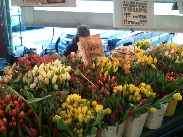 The tulip stand at Pike Place Market in Seattle, brimming with red and yellow tulips