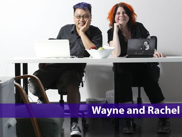 Photo of Wayne Lee and Rachel Young, sitting side by side at a desk with their laptops