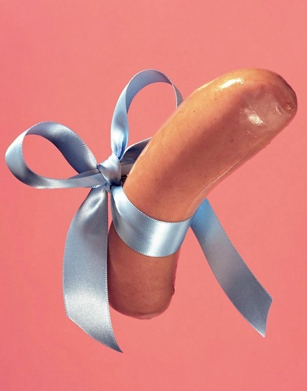 A moist pink sausage, tied in a baby blue bow