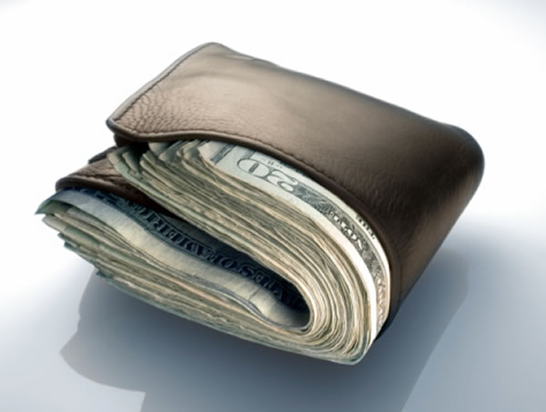 Photo: Leather wallet, filled to bursting with US $20 bills.