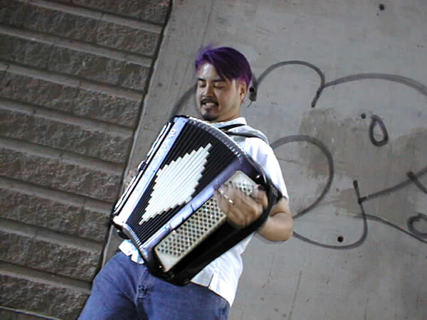 Joey deVilla plays accordion in an alley
