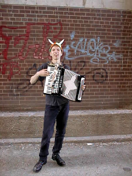 Karl Mohr plays accordion in an alley.