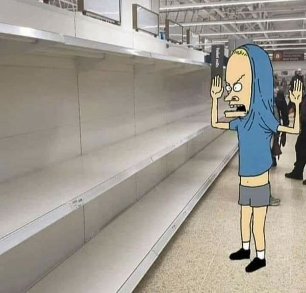 Photo: “Cornholio” standing in a grocery aisle with empty toilet paper shelves.