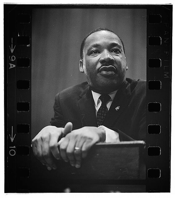 Dr. Martin Luther King, Jr. taking a break at the podium.