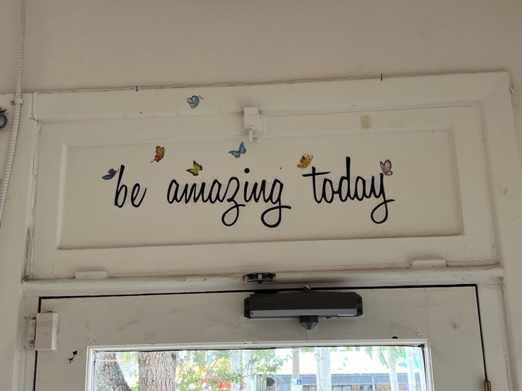 Photo: Sign above door that reads “Be amazing today.”