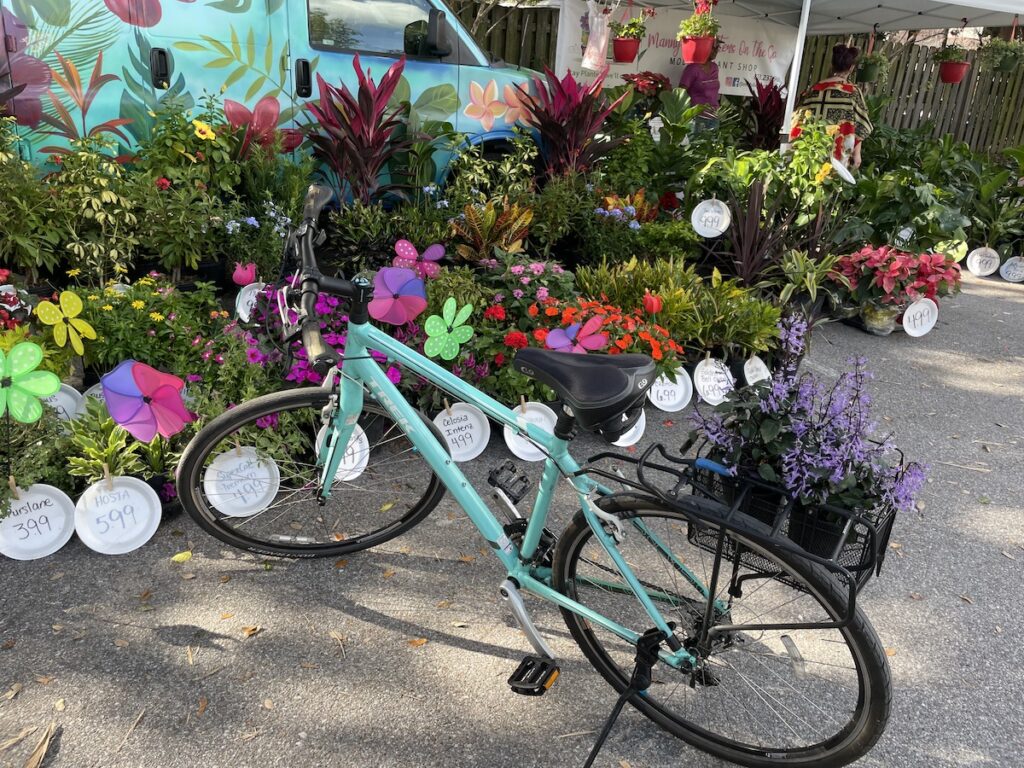 Joey deVilla’s bike in front of a flower stand.