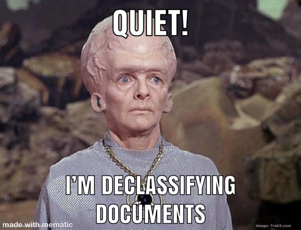 Talosian (Star Trek alien with giant, veiny head) with caption “Quiet! I’m declassifying documents.”