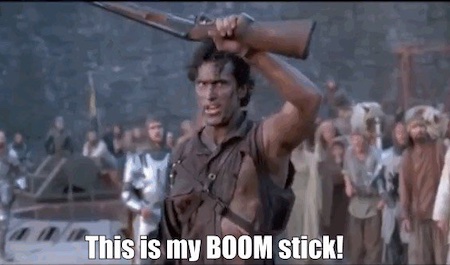 Still from “Army of Darkness” where Ash holds up his shotgun and announces “This is my BOOM STICK!”