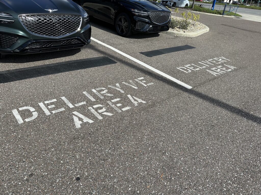 Parking spots, where one is labeled “Delivery area” while another is labeled “DELIRYVE area.”