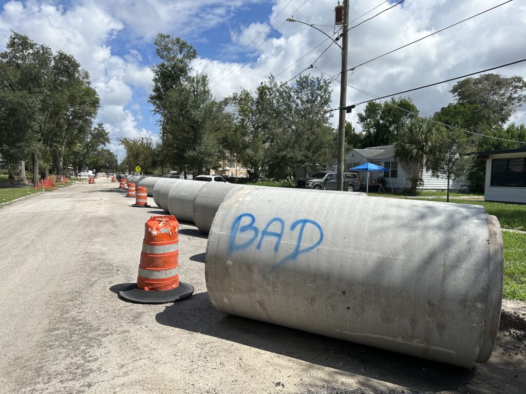 A sewer pipe segment with the word “BAD” spray-painted on it.